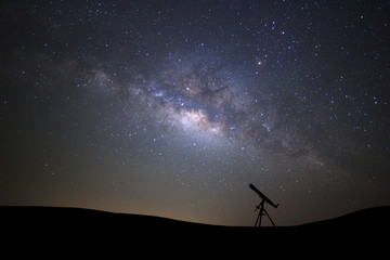 Wall Mural - silhouette of telescope watching the wilky way galaxy with stars and space dust in the universe