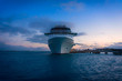 Water level view of cruise ship bow, docked at sunset, bermuda