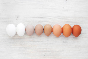 Wall Mural - Several kinds of eggs on the white wooden table