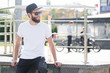 © 4Max - Hipster handsome male model with beard wearing white blank t-shirt with space for your logo or design in casual urban style