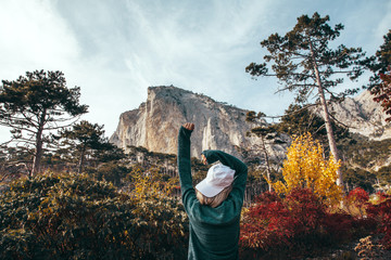Wall Mural - girl traveling in autumn forest by the mountain