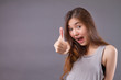 exited woman giving thumb up studio isolated portrait
