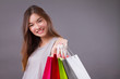 happy smiling shopper, woman holding shopping bag isolated