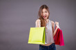 exited, surprised, happy smiling shopper, woman holding shopping bag isolated