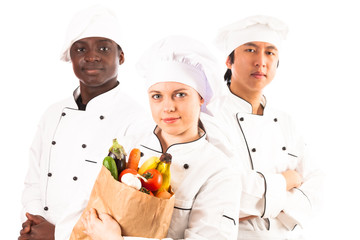 Multi-ethnic Group Of Cooks Holding Groceries