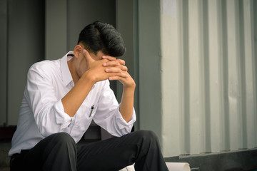 worried businessman sitting after losing job, stressed concept