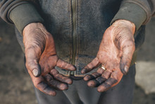 Worker showing his dirty hands