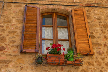 Wall Mural - Traditional façade of Italian house in the small magical and old village of Pienza, Val D'Orcia Tuscany – Italy