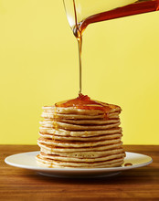 Pouring Maple Syrup On A Stack Of Pancakes