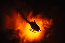 Helicopter Over Fire Sunset Horizon. War Concept. Military Scene Of Flying Helicopter Fire Backgroung Effect. Decoration