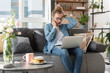 © Yakobchuk Olena - Disappointed young woman doing work at home