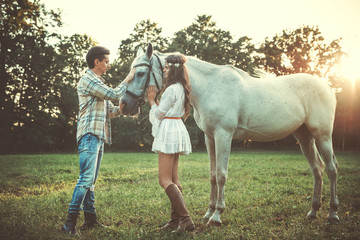 Wall Mural - Young happy couple and beautiful horse