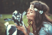 Young Woman And Funny Friendly Goat