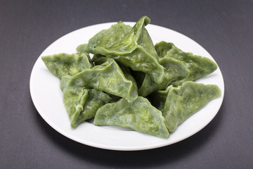 Green dim sum, chinese food. Dumplings with beef meat or mashed potatoes or cottage cheese in the dough with spirulina