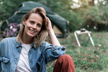 Wall Mural - Happy young woman relaxing in camping