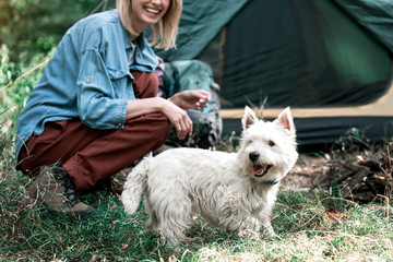 Wall Mural - Carefree girl having fun with pet in forest