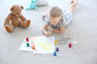 © Africa Studio - Cute little girl painting picture and spilled water on carpet