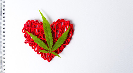 Wall Mural - Marijuana leaf on a heart shape in notebook