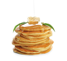 Sticker - Pouring honey onto stack of tasty pancakes on white background