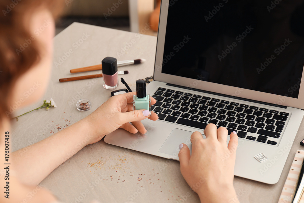 Woman working with laptop at table