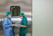 Surgeons Checking A List In An Operating Room