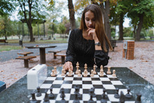 Elegant Woman Playing Chess In Park