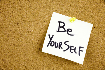 A yellow sticky note writing, caption, inscription Be your best self - positive words on a slate blackboard in black ext on a sticky note pinned to a cork notice board