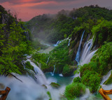 Fototapeta Do pokoju - foggy and multicolored dawn over beautiful waterfalls in the park of plitvice lakes in croatia