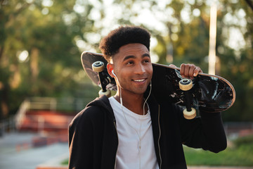 Sticker - Young happy skateboarder man holding skateboard