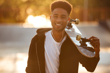 Sticker - Young skateboarder man holding skateboard