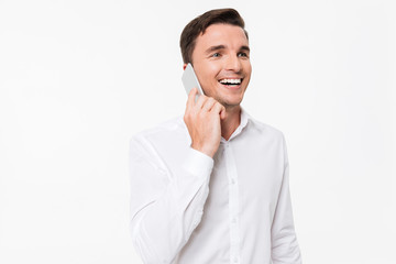 Wall Mural - Portrait of a cheerful young man in a white shirt talking