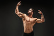 Very brawny guy bodybuilder posing. Beautiful sporty guy male power. Fitness muscled man.