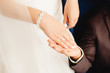 © Parilov - Marry me. Bride and groom's hands with wedding rings