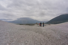Wide Angle View Of People And Helicopter On Taku Glacier On Cloudy Day
