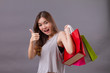 woman shopping with shopping bag and thumb up hand sign, good shopping experience concept