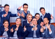 © Gennadiy Poznyakov - Business people office life of team people are happy with thumb up sitting table. Cabinets with folders in the background. Revenue exceeded expenditures for year.