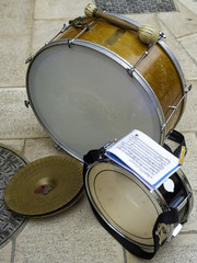 Drum, cymbal and bass drum used by musicians during a religious festival. The music score is visible