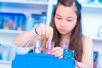 Poster - schoolgirl is experimenting with a hydrogen fuel cell