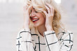 © Kayla Snell/Stocksy - Portrait of young woman with head in hands