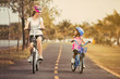© torwaiphoto - Asian mother and daughter cyclist in the park.