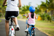 © torwaiphoto - Mother and son are cycling in the park.