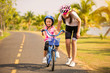 © torwaiphoto - Mother teaching her daughter cycling