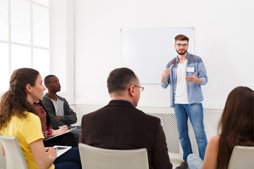 Young man doing presentation in office copy space