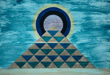 Pyramid And Sun Design On Wood Background