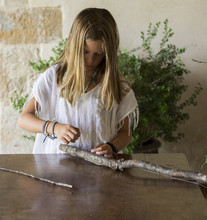 Girl Playing With A Handmade Bow