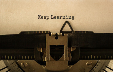 Wall Mural - text keep learning typed on retro typewriter