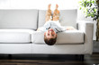 © Louis-Paul Photo - Young Boy Relaxing On Sofa At Home
