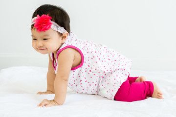 Canvas Print - Portrait of adorable baby crawling on a white floor  with head band