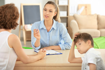 Wall Mural - Young child psychologist working with family in office