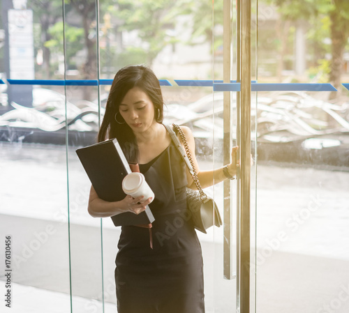 Business Woman Is Walking Through The Front Door Of Her